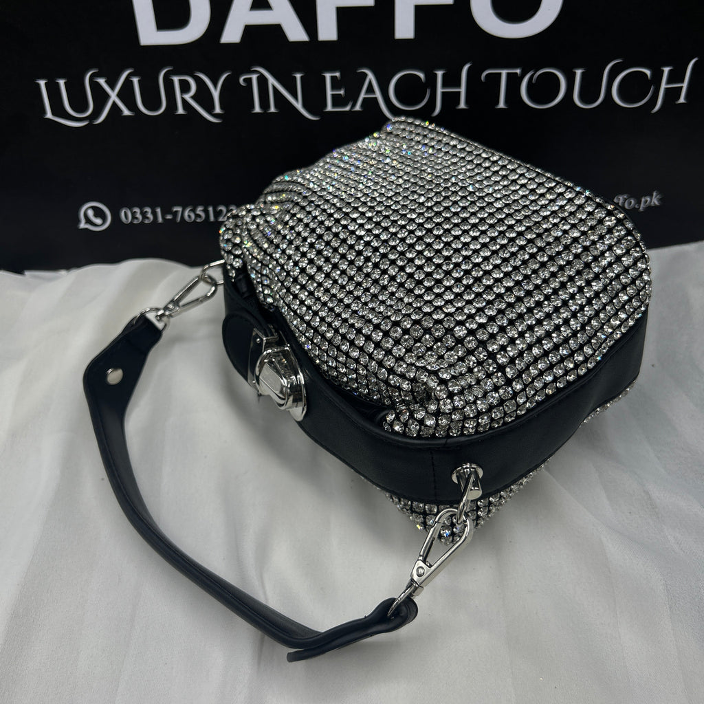 Studded handbag with 'Daffo' branding on a black background
