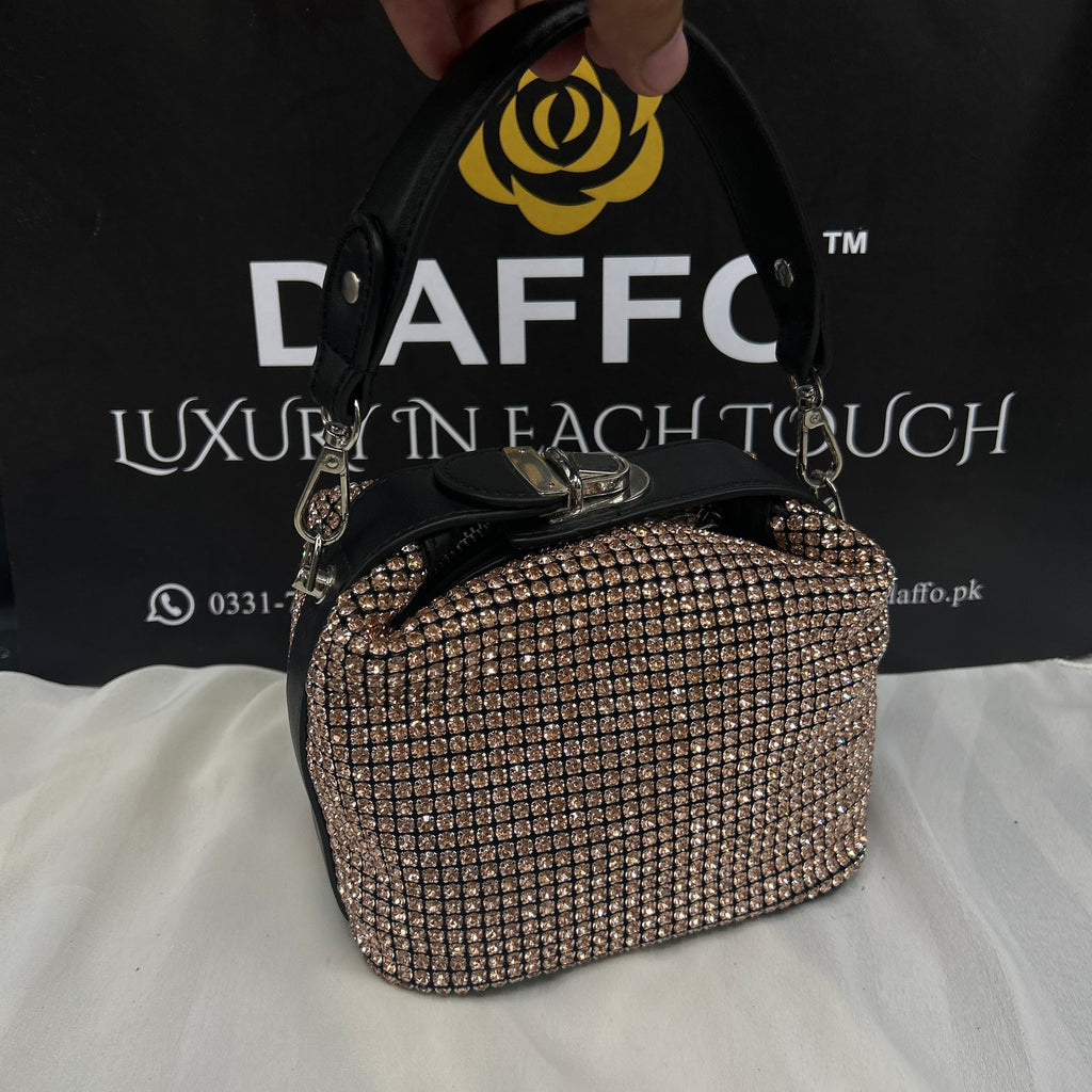 Hand holding a sparkly handbag 