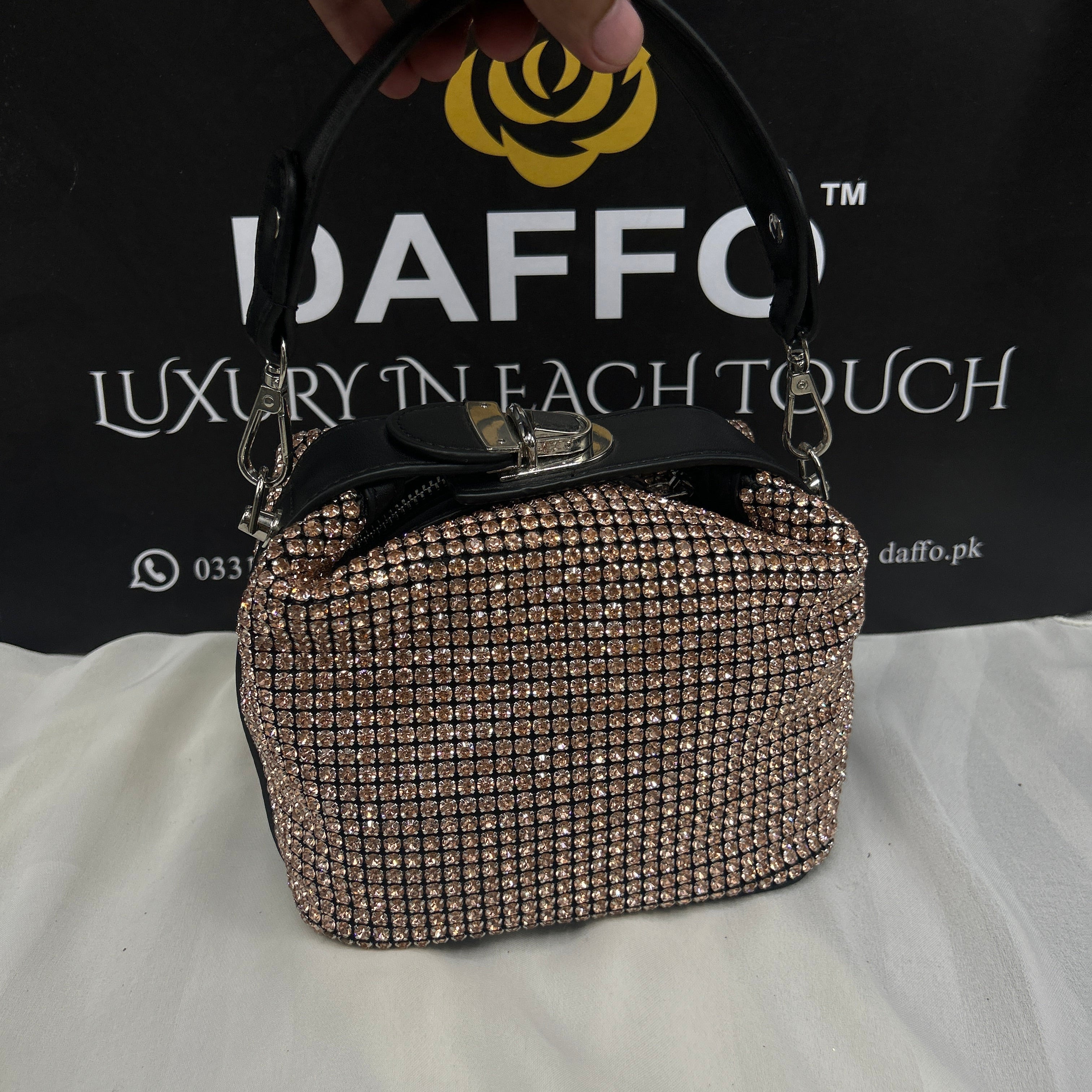 Hand holding a sparkly pouch 